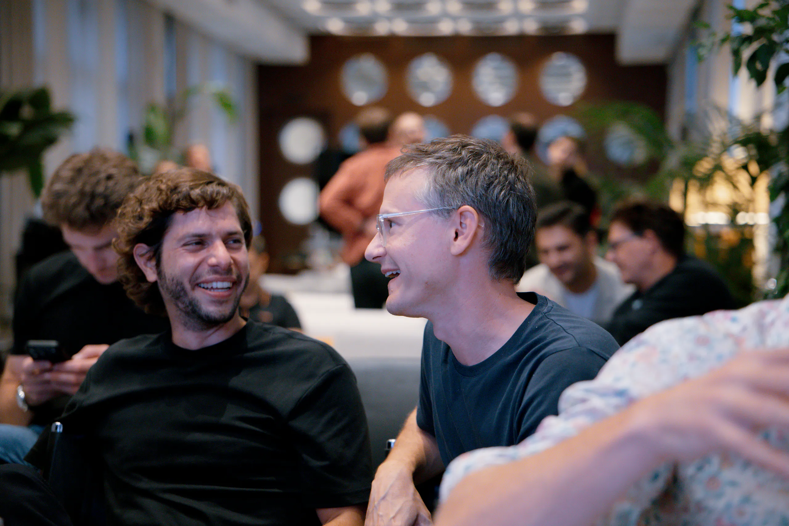 Two entrepreneurs smiling and chatting at DotsHub