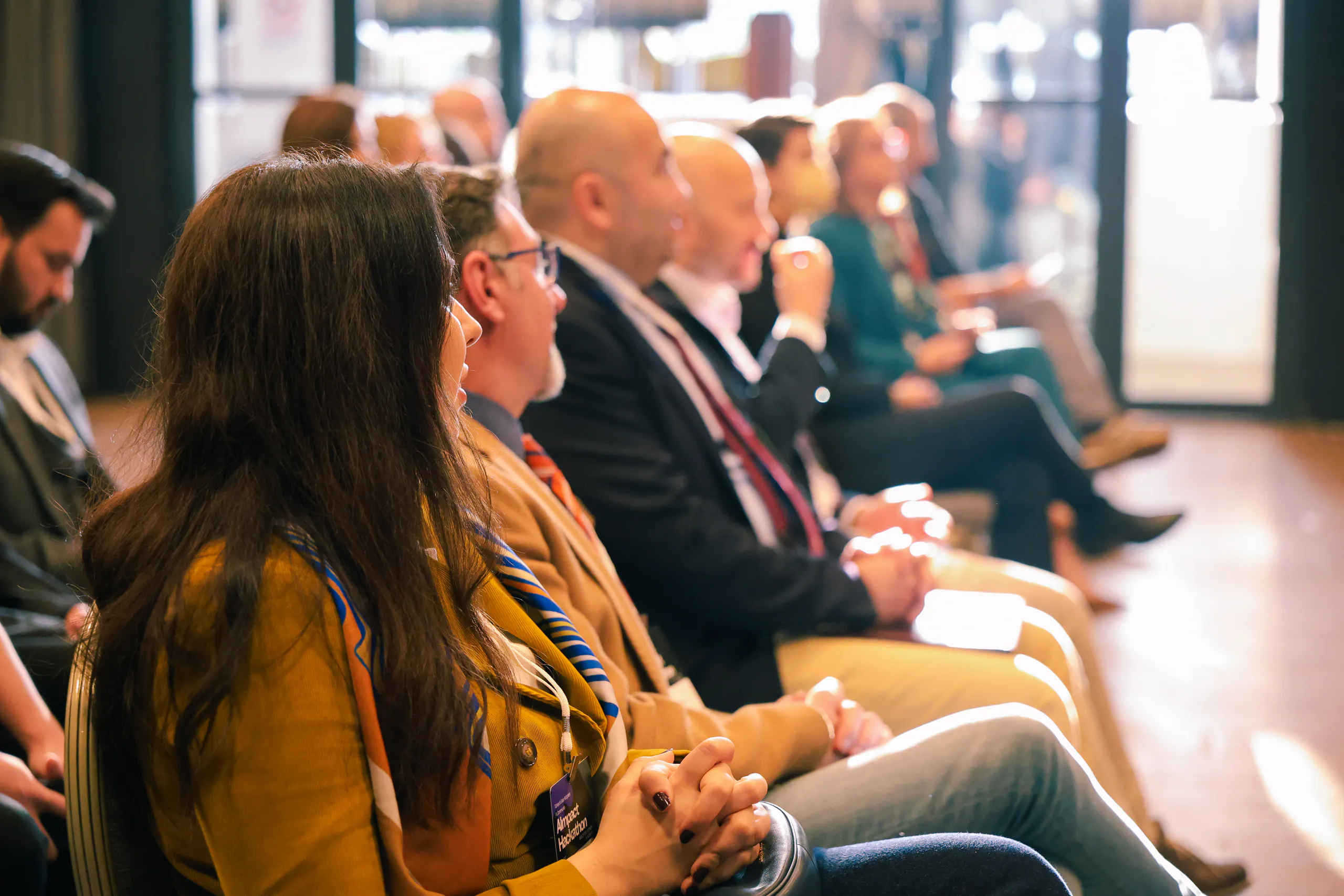 Participants seated in rows listening to the stage at a DotsHub event